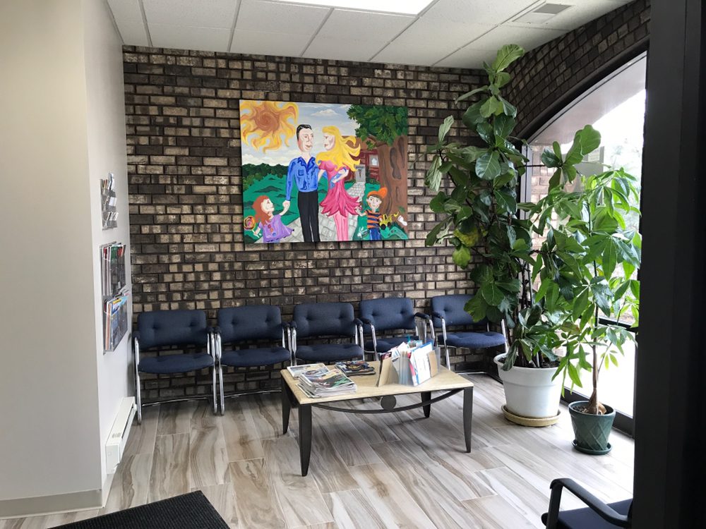 Comfortable waiting room with family artwork and natural light